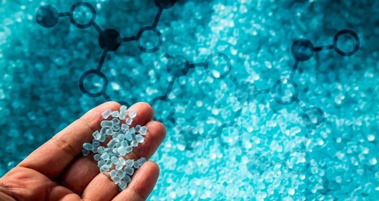 Polymer granules held above turquoise raw material